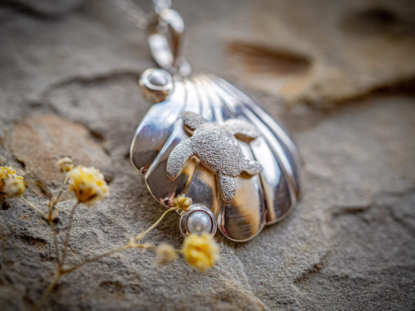 Sterling silver turtle resting on a seashell with two freshwater cultured pearls